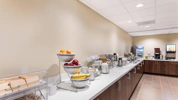 A breakfast bar with various food items and beverages.