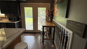 A modern kitchen with a dining area, a ceiling fan, and a sign indicating WiFi availability. - Spokane Indoor Pool Home (Spokane)
