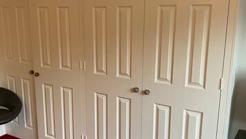 A set of white double doors with a red carpet leading to them.