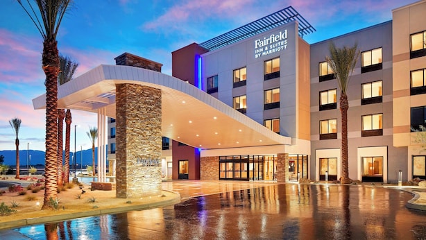A hotel with a modern design, featuring a prominent entrance with a covered walkway and a pool area. - Fairfield by Marriott Inn & Suites Indio Coachella Valley (Indio)