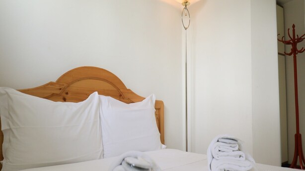 A neatly made bed with white linens and two folded towels on the bed. - Welc-oM Panoramic (Padova)