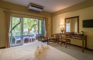 A hotel room with a bed, a desk, a chair, a TV, and a balcony with chairs. - Lalisa Hotel Aonang (Krabi)