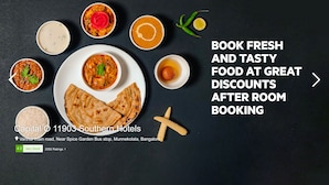 A variety of Indian dishes on a table, including a plate of naan bread, with text promoting food discounts after room booking at a hotel. - OYO 776 Royal Heritage (Calangute)