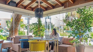 A modern interior with a sofa, chairs, a table, and a laptop. - Maison 66 Riviera Hotels (Alimos)