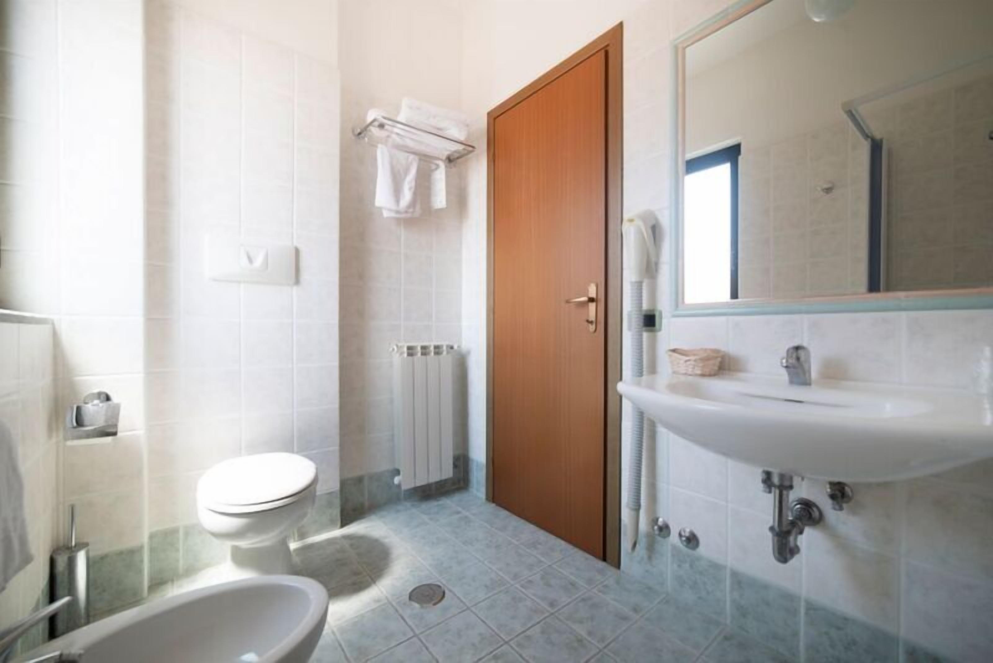 superior triple room | bathroom | rainfall showerhead, hair dryer, towels