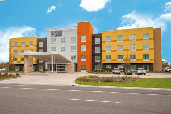 A multi-story hotel with a modern design, featuring a mix of yellow, orange, and grey colors. - Fairfield Inn & Suites by Marriott LaPlace (LaPlace)