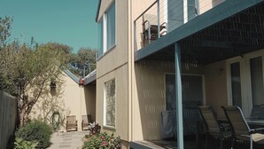A residential building with a covered patio, outdoor seating, and a garden area. - Lonsdale Shores in Point Lonsdale (Point Lonsdale)