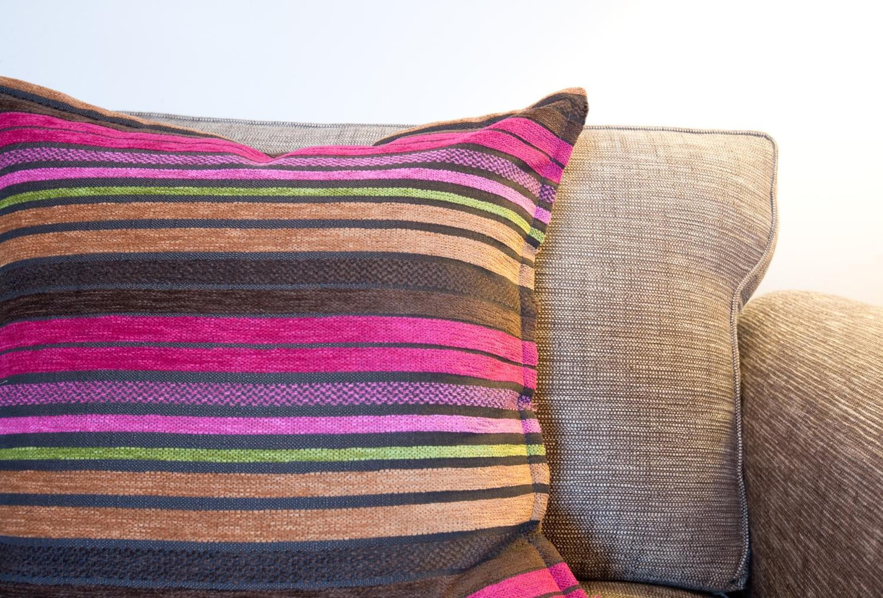 A striped pillow on a couch.
