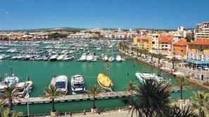 Stroll along the marina, surrounded by boats and picturesque Mediterranean architecture.