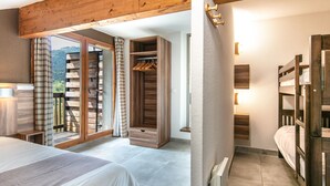 Un dormitorio con cama, armario de madera, radiador y vistas al exterior.