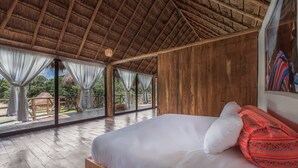 A wooden room with a bed, large windows, and a thatched roof. - Seclusive & Relaxing villa in the jungle of Xpu-Ha by Happy Address (Kantenah)