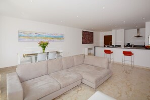 Apartment | Living room | Flat-screen TV - Stylish 2BR a few steps to the beach with pools by Happy Address (Playa del Carmen)