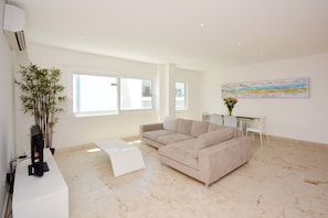 Apartment | Living room | Flat-screen TV - Stylish 2BR a few steps to the beach with pools by Happy Address (Playa del Carmen)