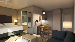 Ein Hotelzimmer mit Bett, Schreibtisch, Sessel, Sofa und einem kleinen Tisch.