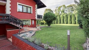A red building with a staircase, a well-maintained lawn, and a row of trees. - are you looking for relaxation, action and culture? (Paszkowka)