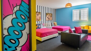 A room with two beds, a sofa, and a window. - The Fox Hotel (Ponce)