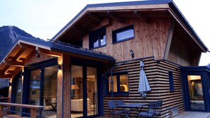 A wooden cabin with a deck, large windows, and a dining area. - Contemporary chalet, close to centre of Chamonix (Chamonix)