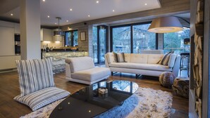 A modern living room with a sofa, armchair, and coffee table. - Contemporary chalet, close to centre of Chamonix (Chamonix)