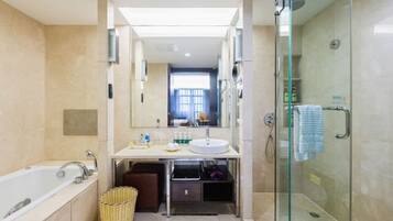 Ein modernes Badezimmer mit einer gläsernen Duschkabine, einer Badewanne und einem Waschtisch.