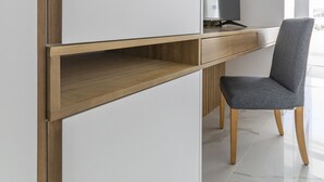 A modern, minimalist room with a built-in desk, a chair, and a television. - Puerto Rico Gran Canaria: Beach and enjoyment at your fingertips (Mogán)