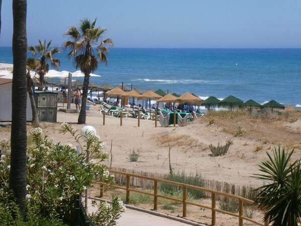 On the beach, sun loungers, beach towels