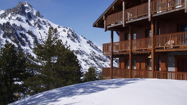 A wooden chalet with balconies overlooking a snowy mountain. - Arc 2000 Chalet, Peaceful Chalet By Slopes with Pool/Spa  (Bourg-Saint-Maurice)