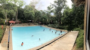 A swimming pool surrounded by trees and small buildings. - Mount Avangan Eco Adventure Park (Coron)