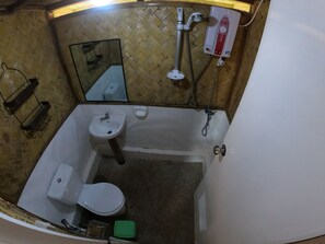 A small bathroom with a toilet, sink, and shower. - Mount Avangan Eco Adventure Park (Coron)