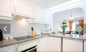 Enjoy cooking in this well-equipped kitchen with a microwave, toaster, and island.