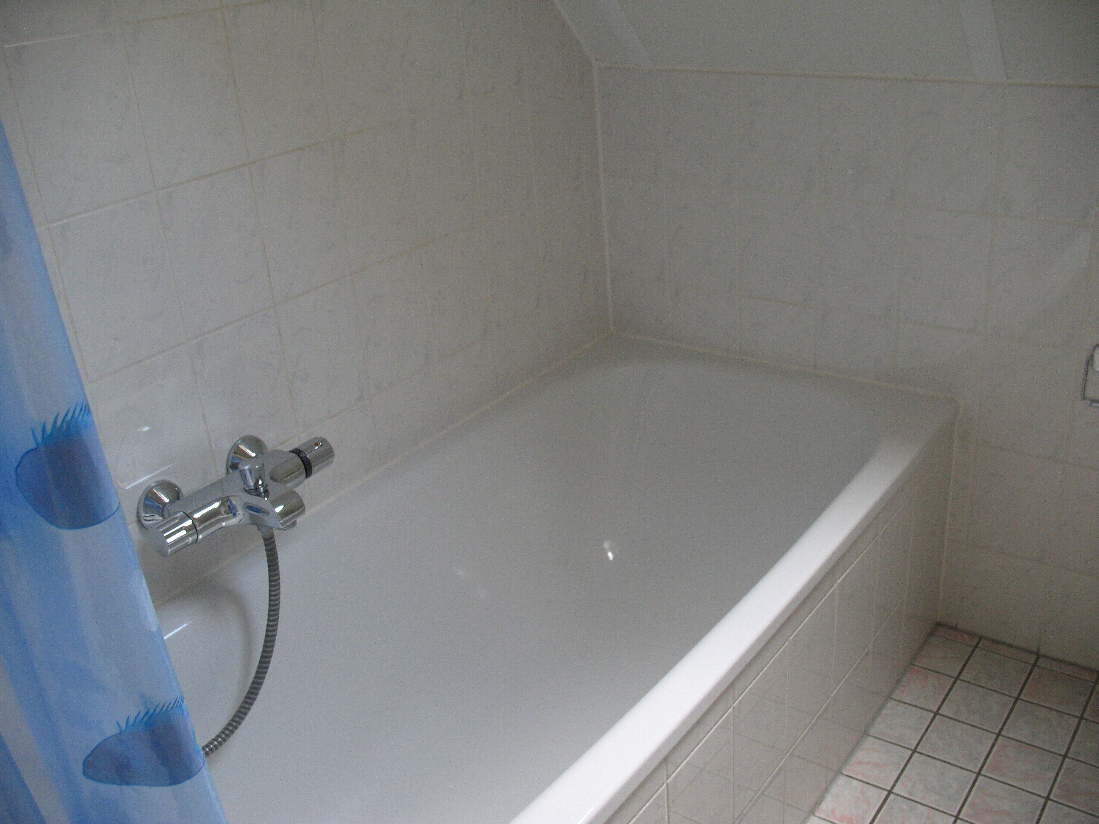 A bathroom with a bathtub, a shower, and a toilet.