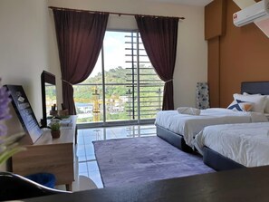 A bedroom with two beds, a desk, and a large window with curtains. - Stay Awhile at Aeropod Sovo Studio (Kota Kinabalu)