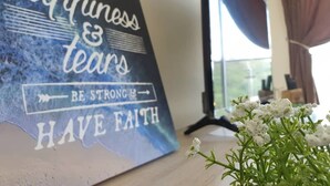A motivational poster with the text "Life is full of happiness & tears, be strong, have faith" on a wall. - Stay Awhile at Aeropod Sovo Studio (Kota Kinabalu)