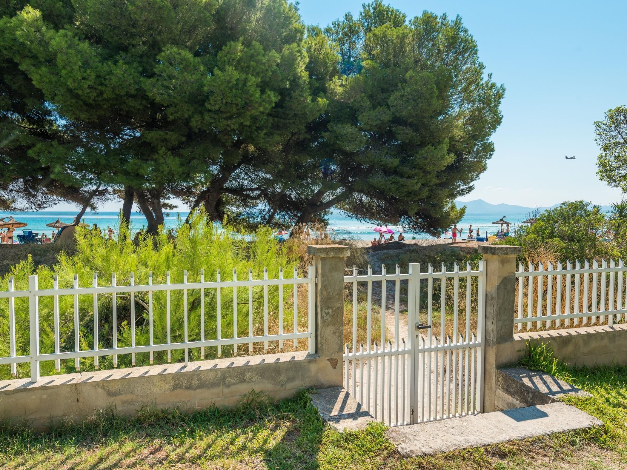 A gated area with a view of the beach and ocean.