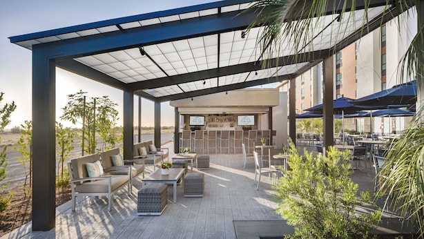 An outdoor patio area with seating and a bar.