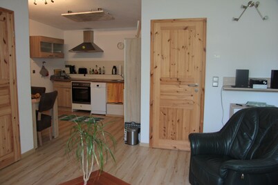 Modernly furnished bungalow with fireplace, surrounded by greenery.