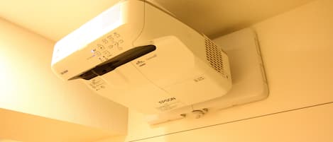 A white Epson projector mounted on a wall.
