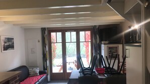 Una habitación con una mesa de comedor, sillas, un banco y una chimenea.
