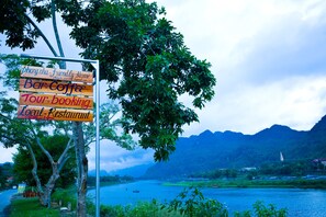 A signboard with services like bar, coffee, tour booking, and local restaurant.