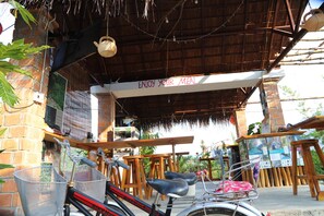 A covered outdoor seating area with a sign reading "ENJOY YOUR MEAL."