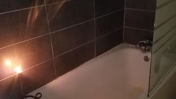 Combined shower/bathtub, hair dryer, slippers, soap