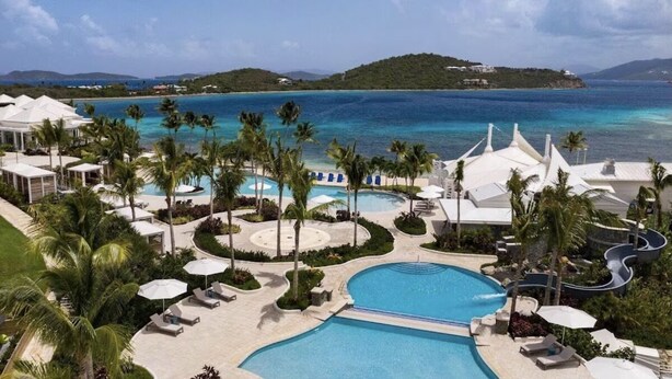 A resort with a large pool, palm trees, and a view of the ocean. - BEACHFRONT LUXURY at the Ritz! NEWLY RENOVATED - MOST DATES Available! (Nazareth)