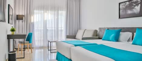 A modern hotel room with two beds, a desk, and a chair.