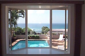 Enjoy a panoramic view of the pool and beach from the comfort of your room.