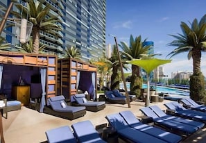 A rooftop pool area with sun loungers, a cabana, and palm trees. - Gorgeous, Luxurious Penthouse Next to Bellagio on the Strip! Call 702-987-6904. (Las Vegas)