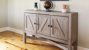 A wooden cabinet with a mirror above it, placed against a wall with a sloped ceiling. - Wine Country Farmhouse Private Lake! kayaks Fire Pit! On The Wine Trail! (Cobden)