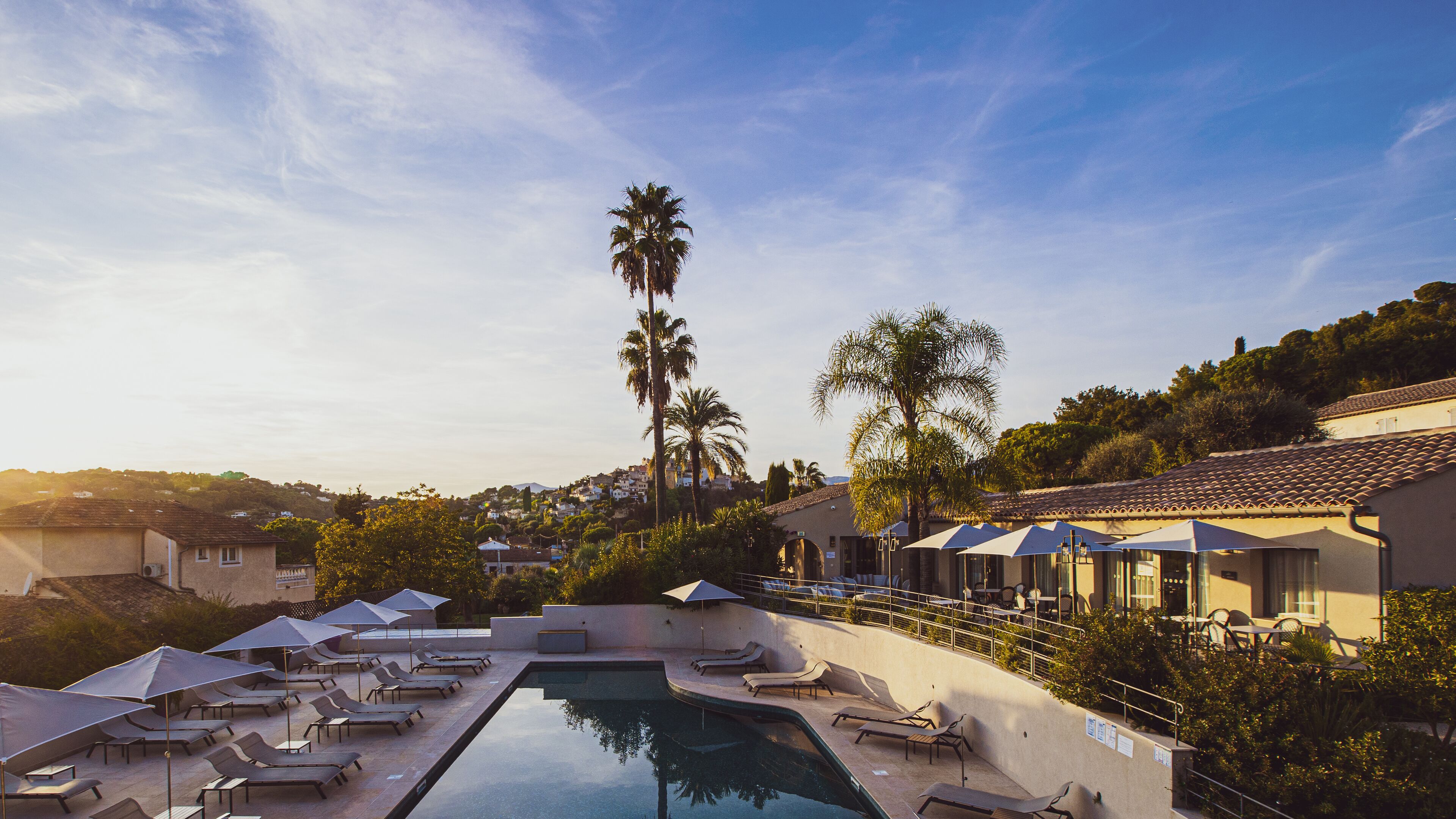 Seasonal outdoor pool, open 9:00 AM to 9:00 PM, pool umbrellas