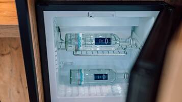 A refrigerator with two bottles of medium-sized water and a bottle of H2O2.