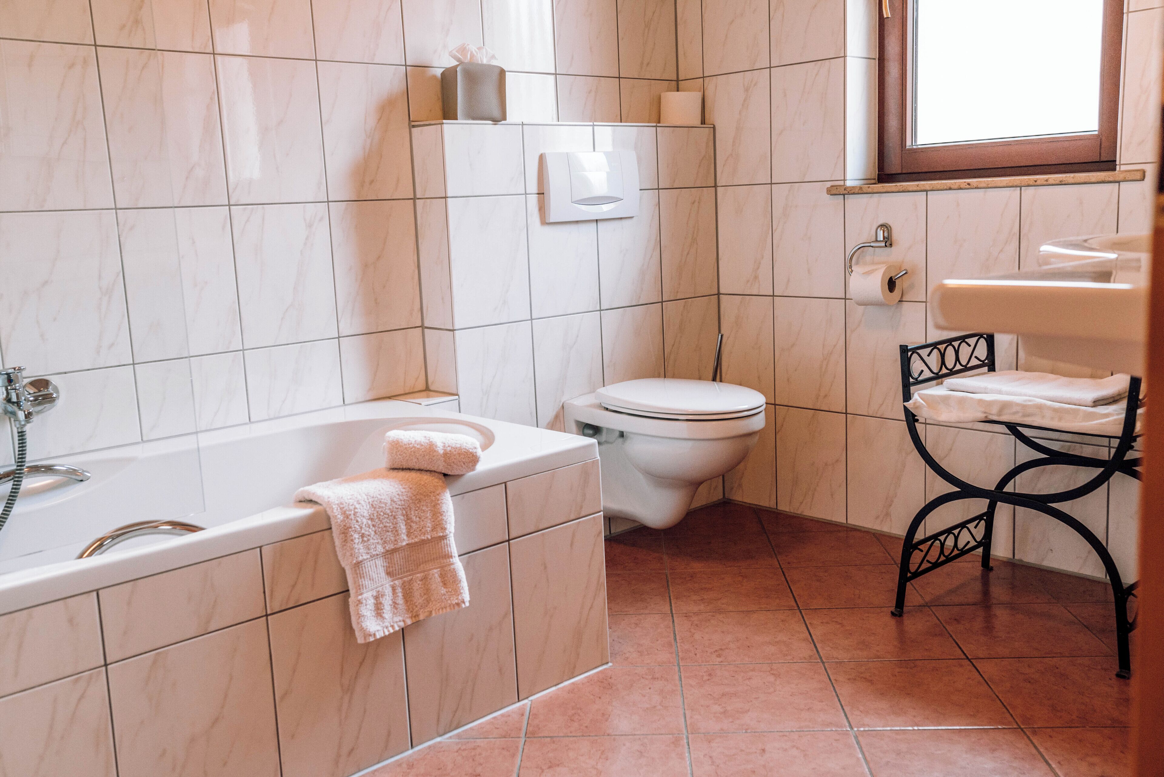 A bathroom with a bathtub, toilet, and sink.