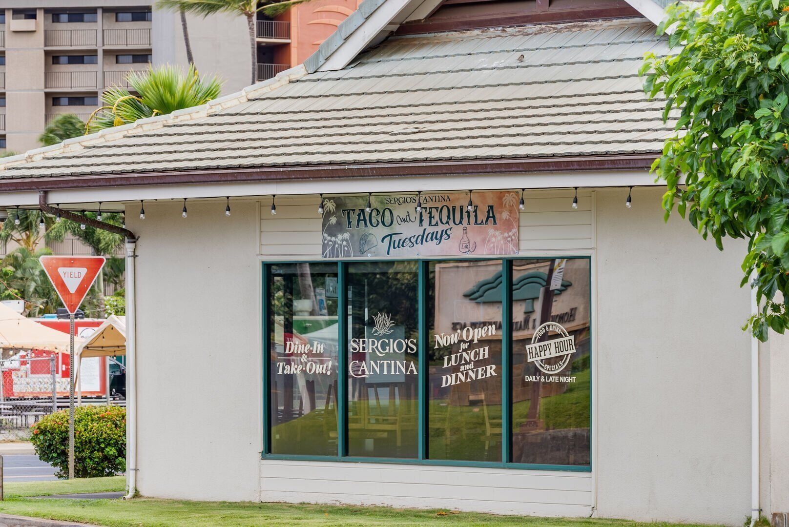 A restaurant named 'Sergio's Antina' with a sign advertising tacos and tequila on Tuesdays.