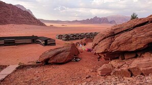 A desert landscape with tents and rocky formations. - Wadi rum light camp (Wadi Rum)